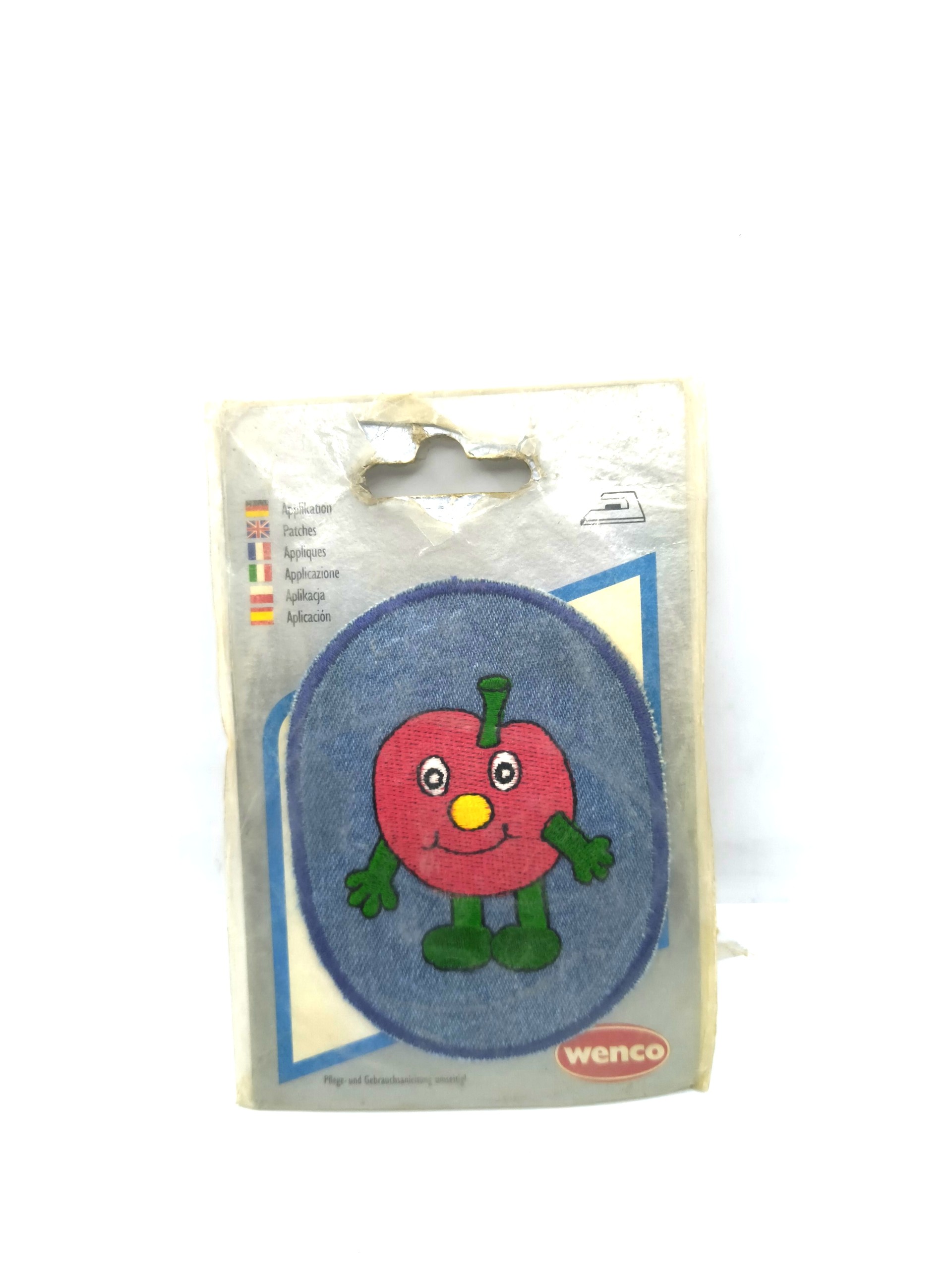 Red apple-shaped badge