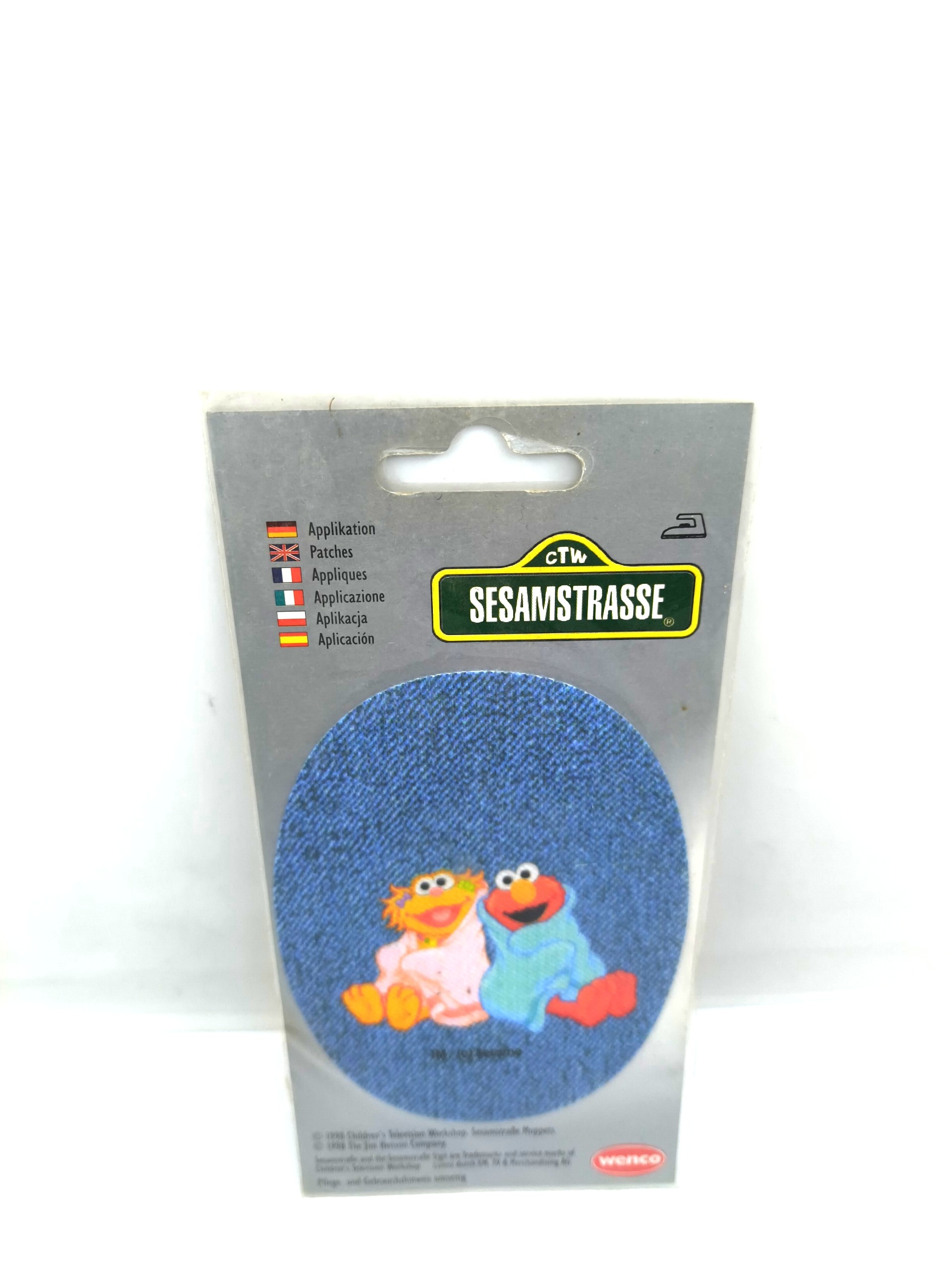 A badge in the shape of two cartoon characters, "Elmo and Zoe," 